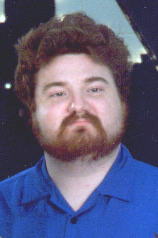 Proud young man with beard in blue shirt